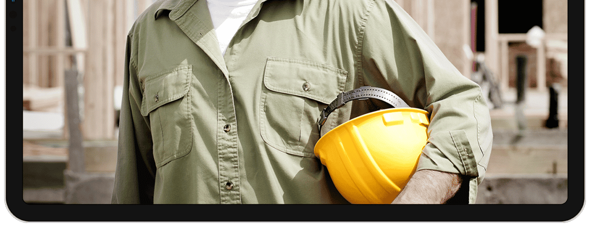 lower fram ipad with contractor holding yellow helmet lower fram ipad with contractor holding yellow helmet