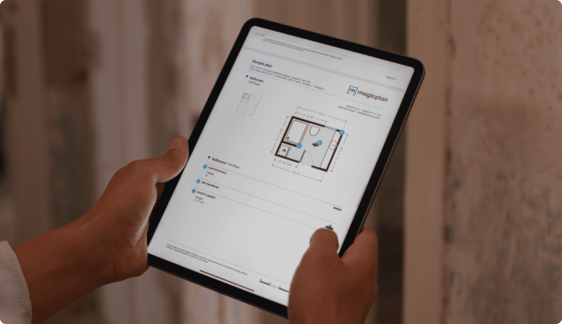 Contractor holding ipad with report of a property with floor plan Contractor holding ipad with report of a property with floor plan