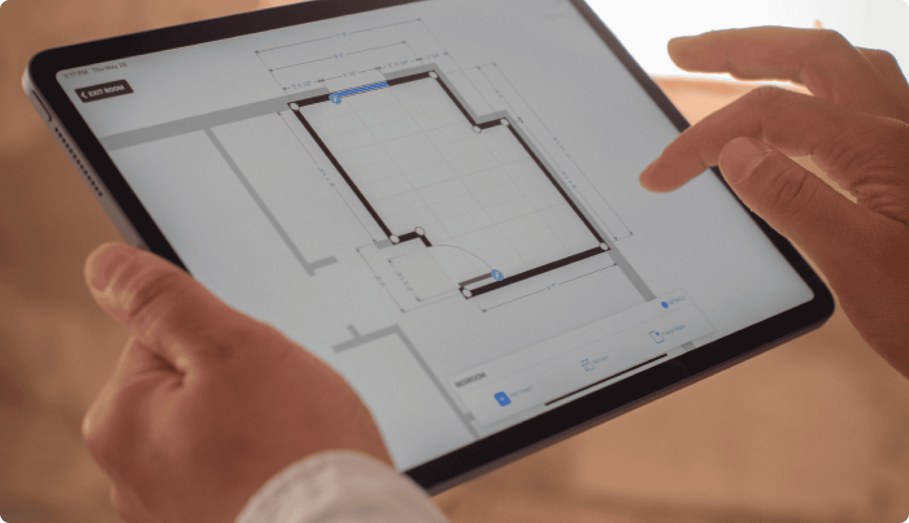 Contractor with an ipad editing floor plan on magicplan app Contractor with an ipad editing floor plan on magicplan app